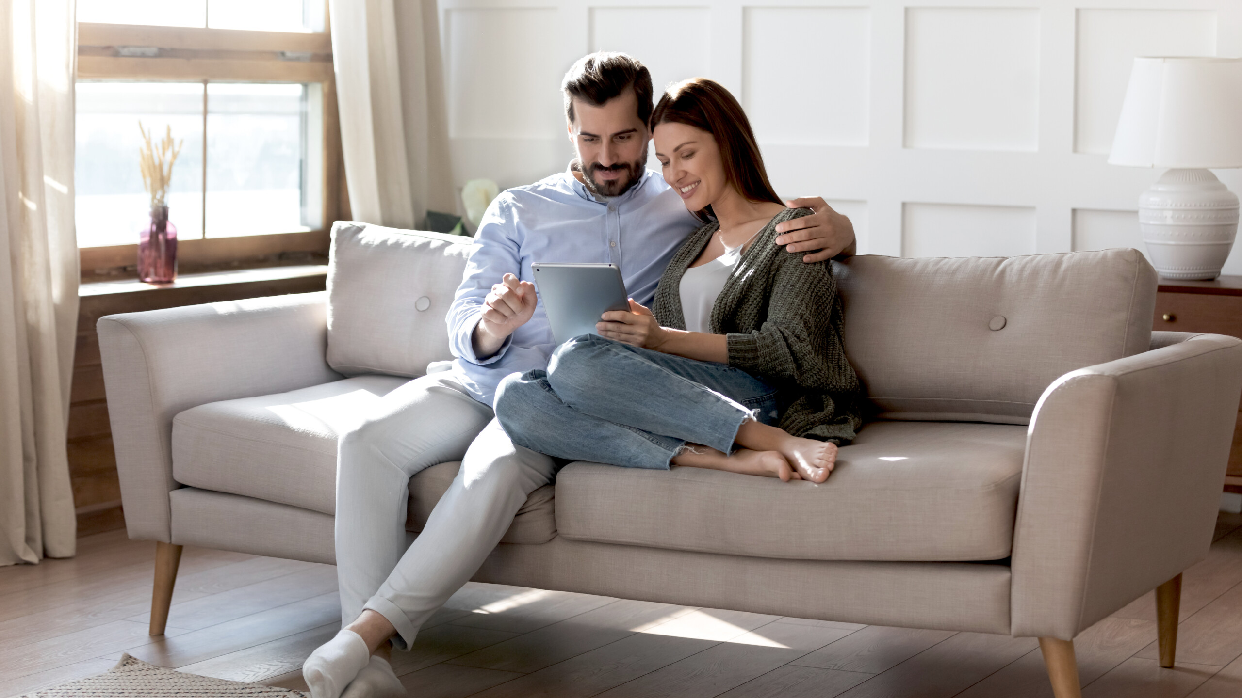 Loving couple shopping online in internet store, using digital tablet